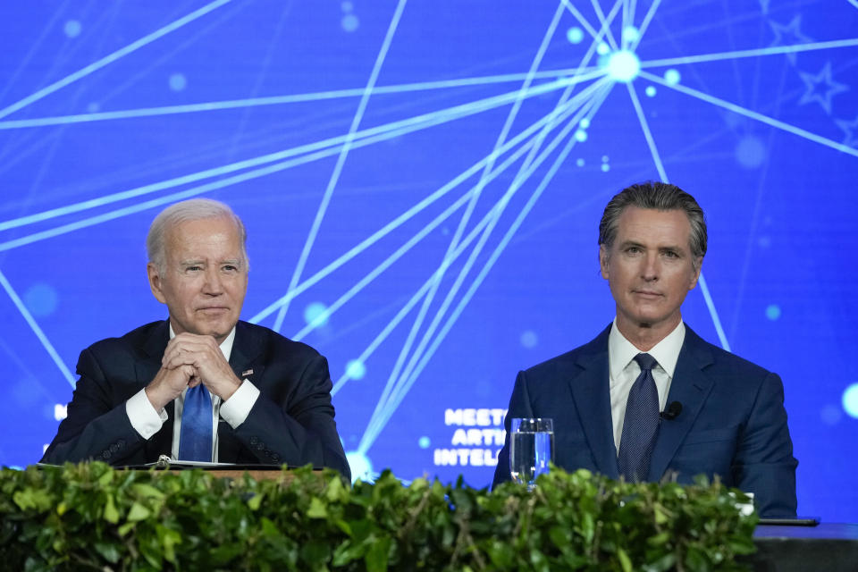 FILE - President Joe Biden and California Gov. Gavin Newsom wait for reporters to leave the room during a discussion on managing the risks of Artificial Intelligence during an event in San Francisco, June 20, 2023. (AP Photo/Susan Walsh, File)