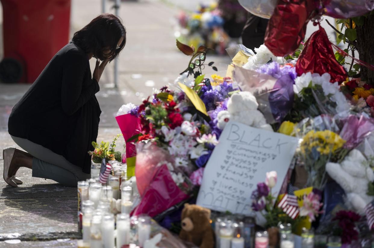 <span class="caption">A memorial to the victims of the mass shooting at a Buffalo, N.Y., supermarket.</span> <span class="attribution"><a class="link " href="https://www.gettyimages.com/detail/news-photo/shannon-waedell-collins-pays-her-respects-after-placing-news-photo/1240744838?adppopup=true" rel="nofollow noopener" target="_blank" data-ylk="slk:Kent Nishimura / Los Angeles Times via Getty Images;elm:context_link;itc:0;sec:content-canvas">Kent Nishimura / Los Angeles Times via Getty Images</a></span>