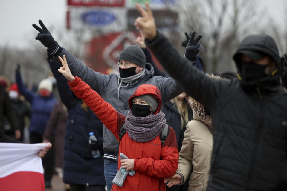 Demonstrators wearing face masks to help curb the spread of the coronavirus gesture during an opposition rally to protest the official presidential election results in Minsk, Belarus, Sunday, Nov. 22, 2020. The Belarusian human rights group Viasna says more than 140 people have been arrested and many of them beaten by police during protests calling for the country's authoritarian president to resign. The demonstrations that attracted thousands were the 16th consecutive Sunday of large protests against President Alexander Lukashenko. (AP Photo)