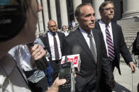 FILE - In this Wednesday, Aug. 8, 2018, file photo, Republican U.S. Rep. Christopher Collins, center, is surrounded by reporters as he leaves federal court, in New York. On Friday, Jan. 17, 2020, U.S. District Judge Vernon Broderick in Manhattan will sentence Collins for conspiring in an insider trading scheme. (AP Photo/Mary Altaffer, File)