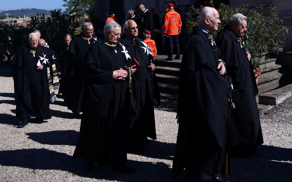 Former Grand Master Matthew Festing, second left, defied a Vatican order to stay away from yesterday's vote - Credit:  FILIPPO MONTEFORTE/AFP