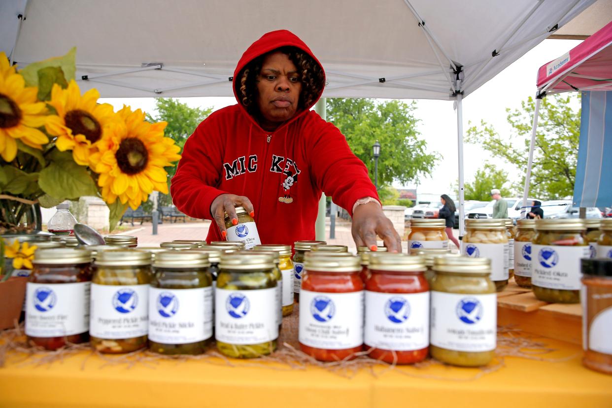 Mildred Daniel arranges jars at the Sweet Spirit Foods booth during the Edmond Farmers Market in 2023. Producers of homemade food items will no longer have to list personal contact information on labels with the signing of House Bill 2975.