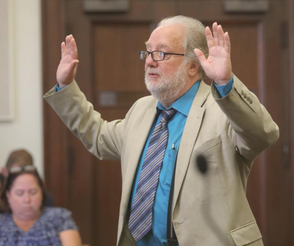 Attorney Pat Summers shows how his client Eric Pursley had his hands in the air when police arrived at Pursley's apartment after he shot Daniel Stein, his landlord, in October.