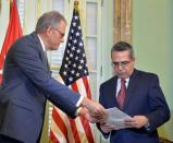 The head of US Interest Section, Jeffrey DeLaurentis (L), gives Cuban Foreign Vice-Minister Marcelino Medina a letter from Obama to Raul Castro, during a meeting in Havana on July 1, 2015