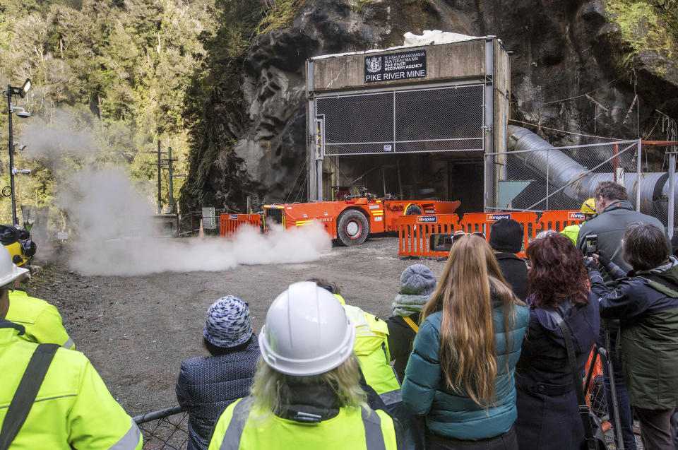 FILE - In this image released by the Pike River Recovery Agency, families of victims watch as a loader enters the Pike River Mine, near Greymouth on the West Coast of New Zealand on May 21, 2019. More than a decade after a methane explosion killed 29 workers at the New Zealand coal mine, police said on Wednesday, Nov. 17, 2021, they have finally found at least two of the bodies thanks to new camera images. (Neil Silverwood/Pike River Recovery Agency via AP, File)