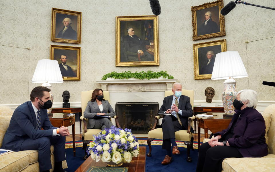 U.S. President Joe Biden is flanked by Vice President Kamala Harris and Treasury Secretary Janet Yellen during the weekly economic briefing as Brian Deese, director of the National Economic Council, listens in the Oval Office at the White House in Washington, U.S., April 9, 2021. REUTERS/Kevin Lamarque