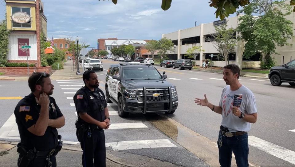 A screen capture shows Escambia County Commission District 4 candidate Stan McDaniels talk with Pensacola Police Department officers while openly carrying a handgun. McDaniels livestreamed the encounter with police on his campaign Facebook page.