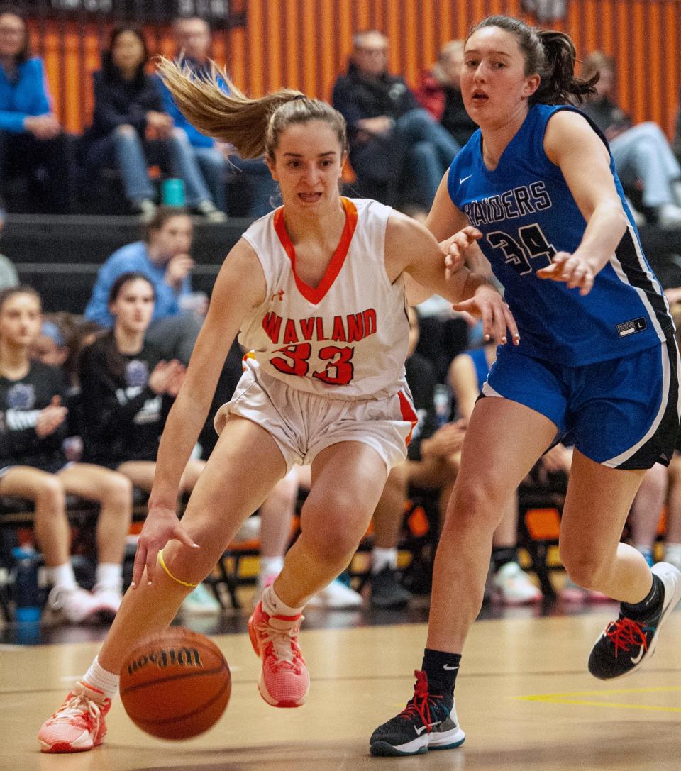 Wayland High School freshman Ella Getz dribbles against Dover-Sherborn sophomore Elliana Scalabrine, Feb. 6, 2023.