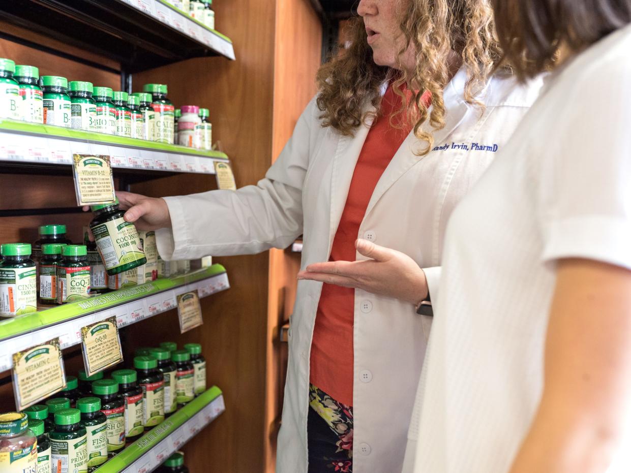 A pharmacist consults with a patient at Rx Clinic Pharmacy in Charlotte, North Carolina.