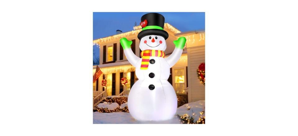 an inflatable giant snowman decoration lit up with interior LED lights
