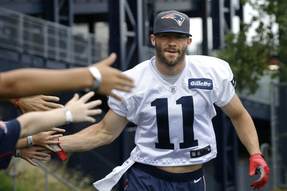 FILE - In this July 31, 2016, file photo, New England Patriots wide receiver Julian Edelman greets fans as he steps on the field before an NFL football training camp practice in Foxborough, Mass. Citing a knee injury that cut his 2020 season short after just six games, Edelman announced Monday, April 12, 2021, that he is retiring from the NFL after 11 seasons. (AP Photo/Steven Senne, File)