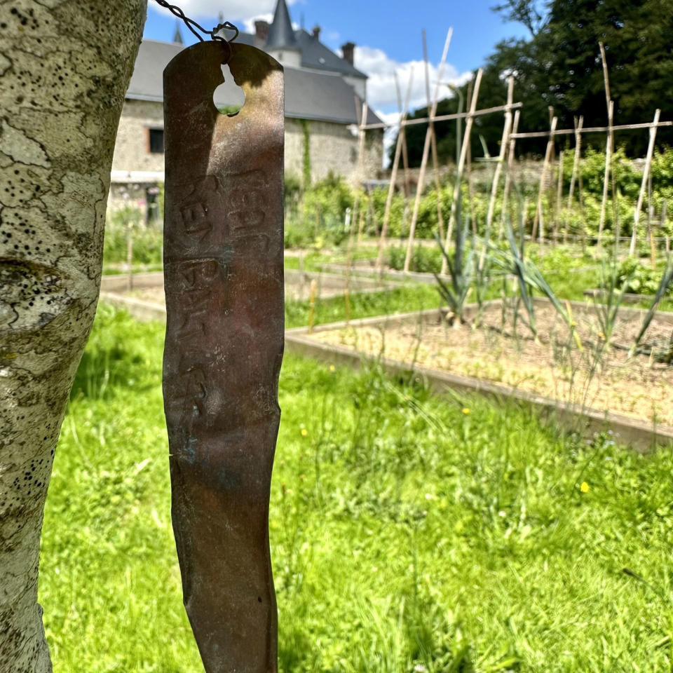 Row of produce with copper sign on a tree