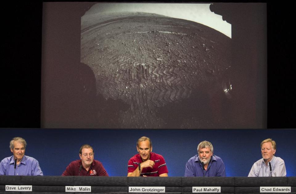 NASA scientists comment on the newest image of the tracks left by NASA's Curiosity rover on the surface of Mars at NASA's Jet Propulsion Laboratory in Pasadena, Calif., Monday, Aug. 27, 2012. From left: Dave Lavery, Program Executive for Solar System Exploration at NASA Headquarters, Mike Malin, imaging scientist for the Mars Science Laboratory, John Grotzinger, MSL project scientist, California Institute of Technology, Paul Mahaffy, NASA Goddard Space Flight Center, and Dr. Chad Edwards, Chief Telecommunications Engineer for the Mars Exploration Program at JPL. The Mars image was taken by a front Hazard-Avoidance camera, which has a fisheye lens. (AP Photo/Damian Dovarganes)