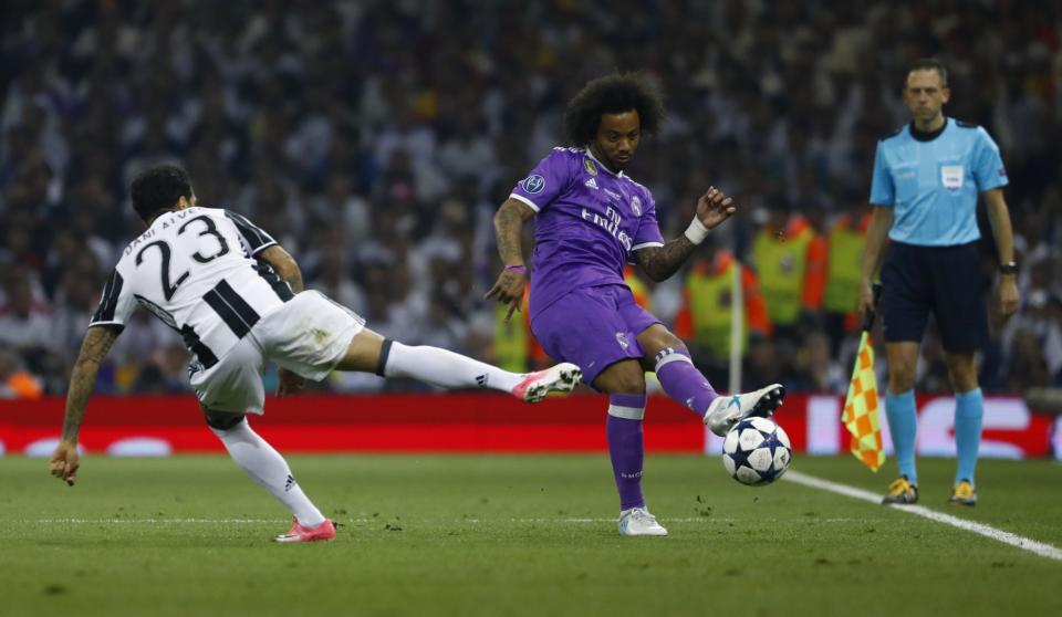 <p>Real Madrid’s Marcelo in action with Juventus’ Dani Alves </p>