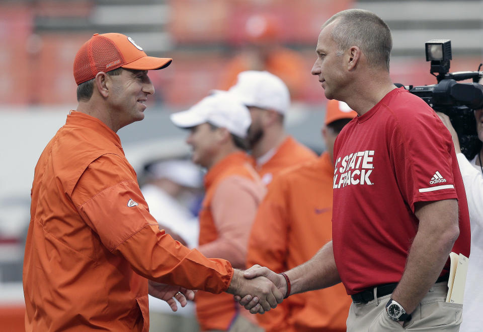 Clemson head coach Dabo Swinney and North Carolina State head coach Dave Doeren shake hands prior to an NCAA college football game in Raleigh, N.C., Saturday, Nov. 4, 2017. (AP Photo/Gerry Broome)