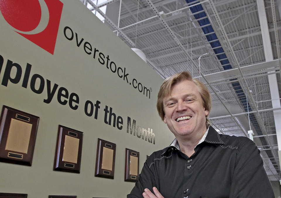 FILE - This March 25, 2010 file photo, Chairman and CEO of OverStock.com Patrick Byrne poses for a picture by the employee of the month wall at the warehouse of Overstock.com outside of Salt Lake City. Election officials and experts are raising alarms about the private fundraising surrounding efforts to expand Republican ballot reviews to more states former President Donald Trump falsely claims he won. While some fundraising details have come to light, information about who is donating the money and how it's being spent is largely exempt from public disclosure. (AP Photo/George Frey, File)