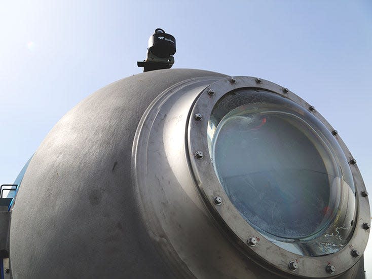 A close-up photo of the viewport of the Titan submersible.