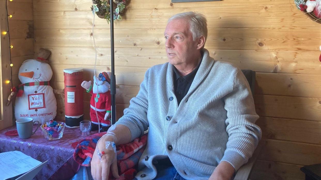 Des Burns receives cancer treatment while sitting in his shed