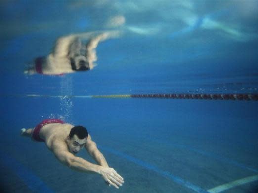 Hungarian swimmer Laszlo Cseh swims underwater during a training session in Budapest April 12, 2012.