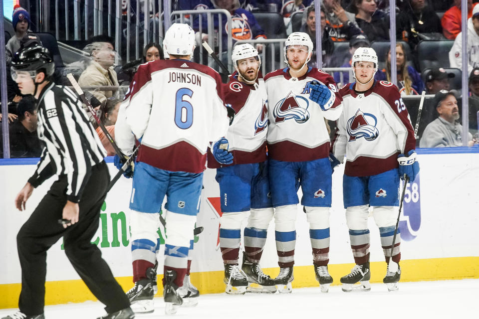 Colorado Avalanche players celebrate after a goal scored by teammate Mikko Rantanen (96) during the second period of an NHL hockey game against the New York Islanders, Saturday, Oct. 29, 2022, in Elmont, N.Y. (AP Photo/Eduardo Munoz Alvarez)