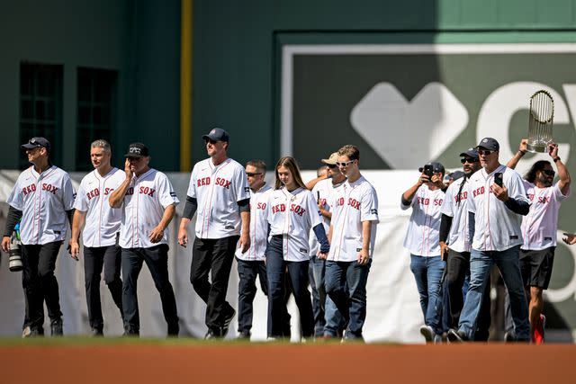 <p>Jaiden Tripi/Getty</p> Members of the 2004 Boston Red Sox with Brianna Wakefield and Trevor Wakefield (center) on April 9, 2024