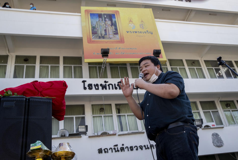 Pro-democracy protest leader Parit Chiwarak speaks from a makeshift stage outside Bang Khen Metropolitan Police Station, Bangkok, Thailand, Monday, Dec. 21, 2020. Several leaders of protest movement report to the police station to answer the charges of defaming the Thai monarchy, the most serious of many offenses of which they stand accused during recent pro-democracy rallies. (AP Photo/Gemunu Amarasinghe)