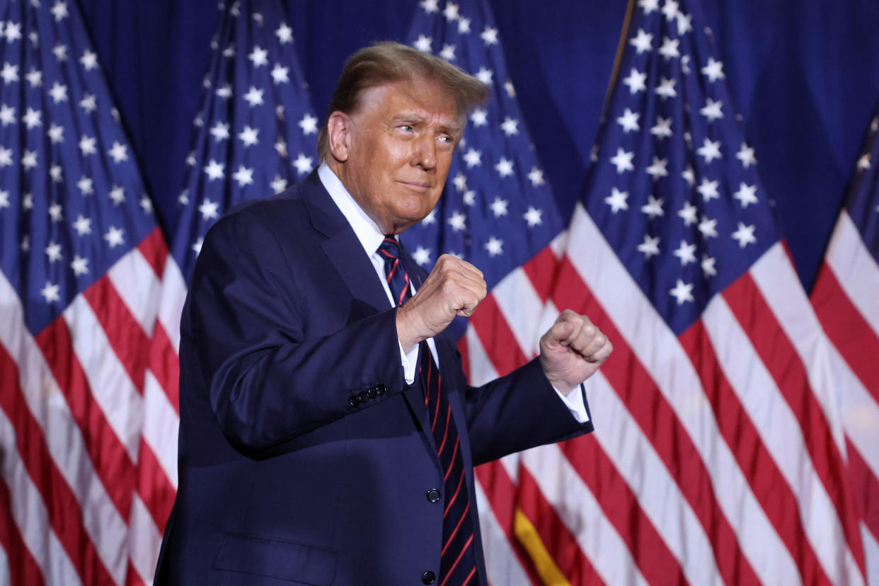 Former President Donald Trump gestures as he takes the stage in Nashua.