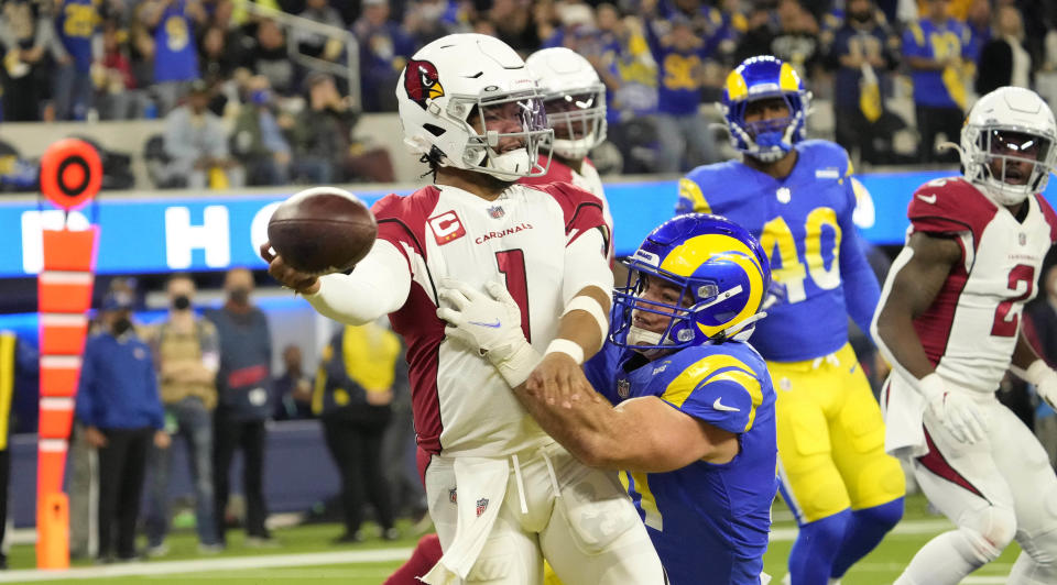 Jan 17, 2022; Los Angeles, California, USA;  Arizona Cardinals quarterback Kyler Murray (1) throws the ball while brought down by Los Angeles Rams linebacker Anthony Hines III (57) during the second quarter of the NFC Wild Card playoff game. The ball was intercepted for a touchdown.