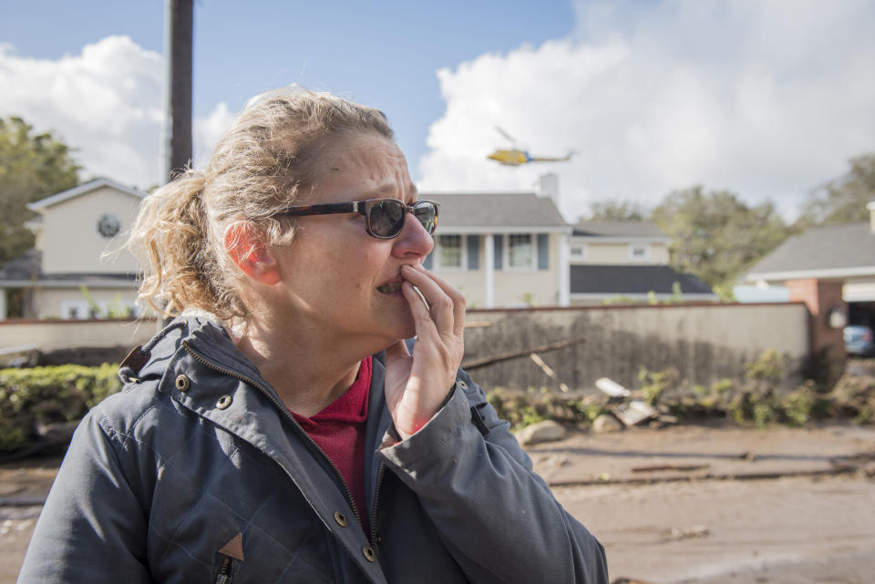 <p>Sara Wilcox looks at the damage done by a mudslide on Olive Mill Rd in Montecito, Calif., on Jan.9, 2018. (Photo: Erick Madrid via ZUMA Wire) </p>