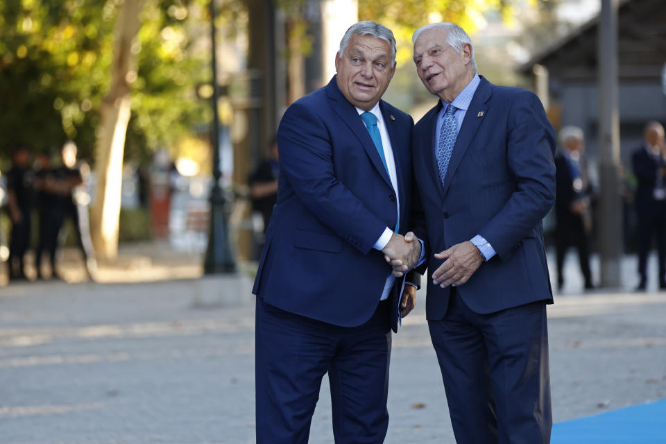 Hungary's Prime Minister Viktor Orban, left, shakes hands with European Union foreign policy chief Josep Borrell on arrival for the 2nd day of the Europe Summit in Granada, Spain, Friday, Oct. 6, 2023. European Union leaders have pledged Ukrainian President Volodymyr Zelenskyy their unwavering support. On Friday, they will face one of their worst political headaches on a key commitment. How and when to welcome debt-laden and war-battered Ukraine into the bloc. (AP Photo/Fermin Rodriguez)