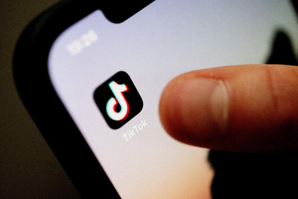 A teenager uses the TikTok app on his smartphone. (Marijan Murat / picture alliance via Getty Images file)