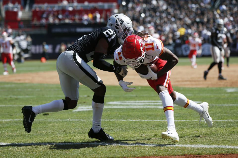 Kansas City Chiefs wide receiver Demarcus Robinson (11) scores a touchdown as Oakland Raiders cornerback Gareon Conley (21) looks on during the first half of an NFL football game Sunday, Sept. 15, 2019, in Oakland, Calif. (AP Photo/D. Ross Cameron)