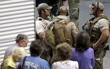 Police officers stand guard at an entrance as attendees are prevented from leaving the Muhammad Art Exhibit and Contest after it was reported that shots were fired outside the venue and a man is down in Garland, Texas May 3, 2015. REUTERS/Mike Stone