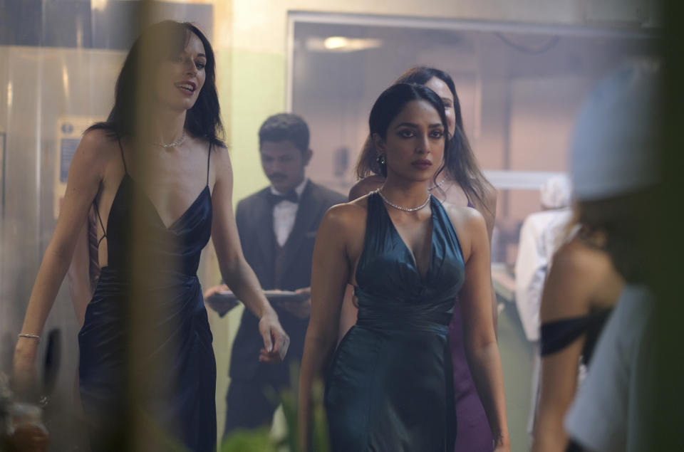 This image released by Universal Pictures shows Sobhita Dhulipala, foreground, in a scene from the film "Monkey Man." (Universal Pictures via AP)