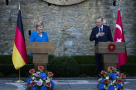 Turkey's President Recep Tayyip Erdogan, right, and German Chancellor Angela Merkel talk to journalists during a joint news conference following their meeting at Huber Villa presidential palace, in Istanbul, Turkey, Saturday, Oct. 16, 2021. The leaders discussed Ankara's relationship with Germany and the European Union as well as regional issues including Syria and Afghanistan. (AP Photo/Francisco Seco)