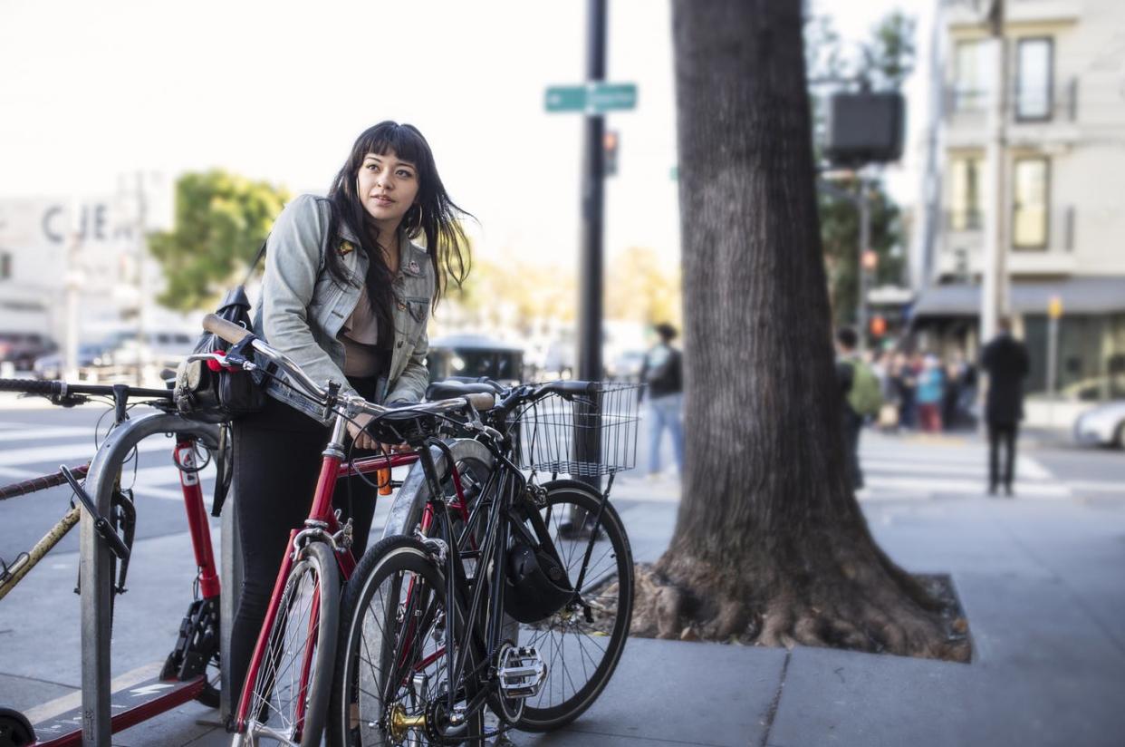 <span class="caption">Women have many more work and educational choices than previous generations, which affect their decisions about having children.</span> <span class="attribution"><a class="link " href="https://www.gettyimages.com/detail/photo/millennial-latina-bicycle-commuting-locking-her-royalty-free-image/1092350028" rel="nofollow noopener" target="_blank" data-ylk="slk:Justin Lewis/DigitalVision via Getty Images;elm:context_link;itc:0;sec:content-canvas">Justin Lewis/DigitalVision via Getty Images</a></span>