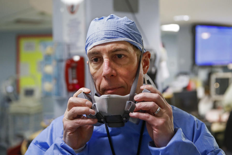 Dr. Anthony Leno, Director of Emergency Medicine, pauses at the end of his shift after his staff revived a patient with COVID-19 who had gone into cardiac arrest, Monday, April 20, 2020, at St. Joseph's Hospital in Yonkers, N.Y. (AP Photo/John Minchillo)