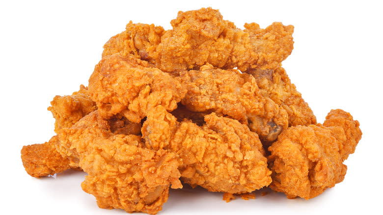 Variety of fried chicken on white background