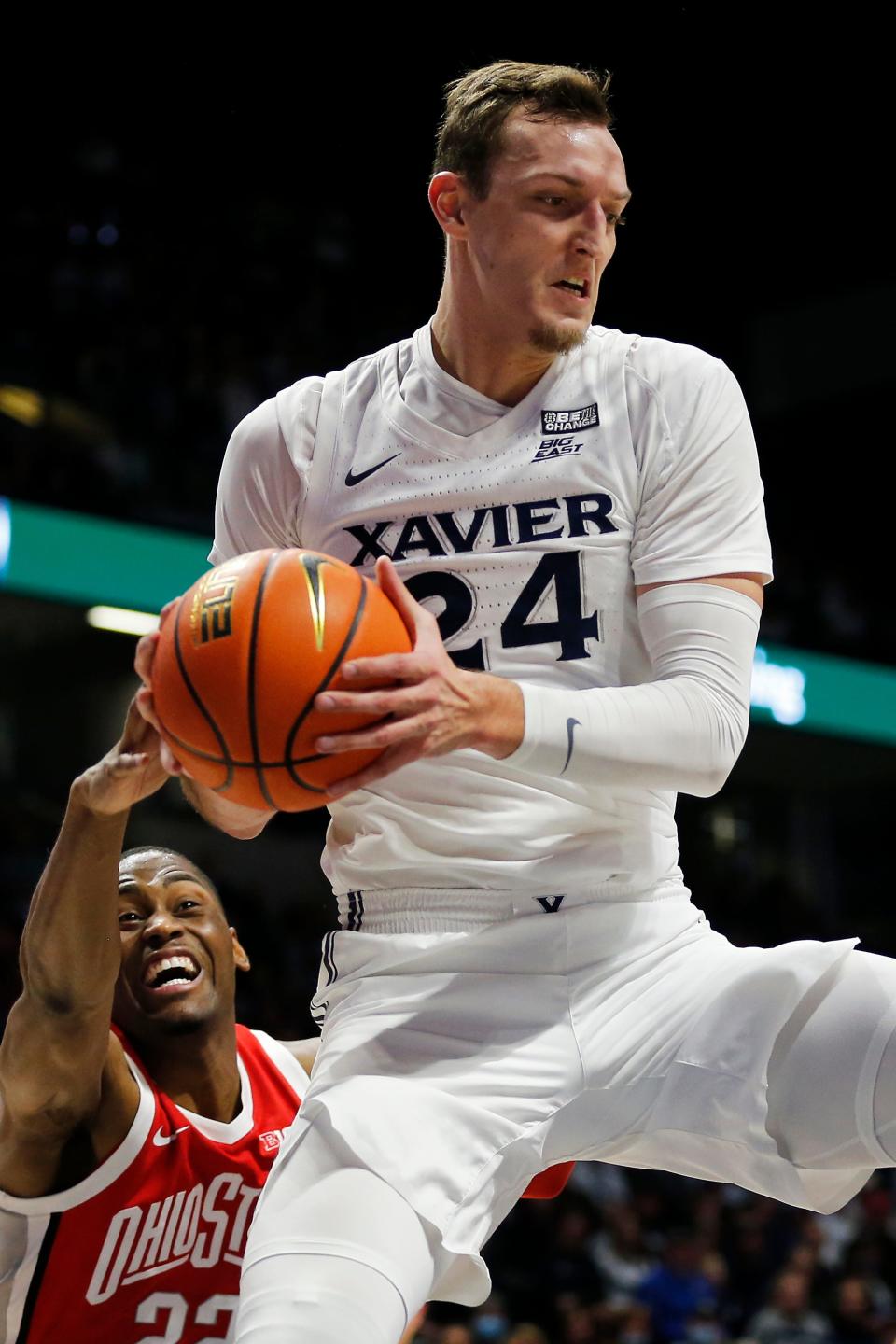 Xavier Musketeers forward Jack Nunge (24) pulls down a rebound over Ohio State Buckeyes guard Malachi Branham (22) in the second half of the NCAA basketball game between the Xavier Musketeers and the Ohio State Buckeyes at the Cintas Center in Cincinnati on Thursday, Nov. 18, 2021. Xavier defeated the 19-ranked Buckeyes, 71-65.