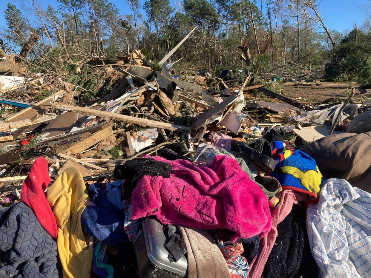 Debris is strewn about following severe weather Wednesday, Dec. 14, 2022, in Keithville, La. A volatile storm ripping across the U.S. spawned tornadoes that killed a young boy and his mother in Louisiana, smashed mobile homes and chicken houses in Mississippi and threatened neighboring Southern states with more punishing weather Wednesday. (AP Photo/Jake Bleiberg)