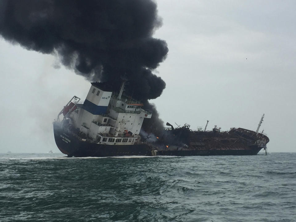 In this photo released by Hong Kong Police, dense, black smoke billows from an oil and chemical tanker after catching fire off the south of Lamma island of Hong Kong, Tuesday, Jan. 8, 2019. (Hong Kong Police via AP)