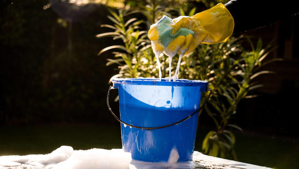 A bucket filled with warm soapy water