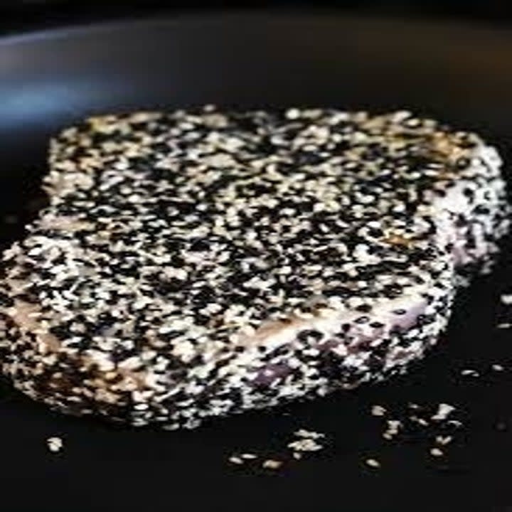 Sesame crusted tuna in a skillet.