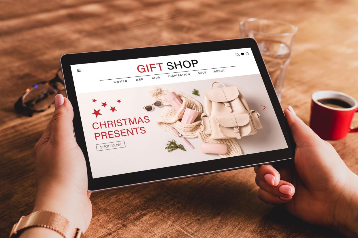 Buying Christmas presents (fashion accessories) online - internet gift shop. Tablet in womanâ€™s hands. Made up illustrative e-commerce content design.
