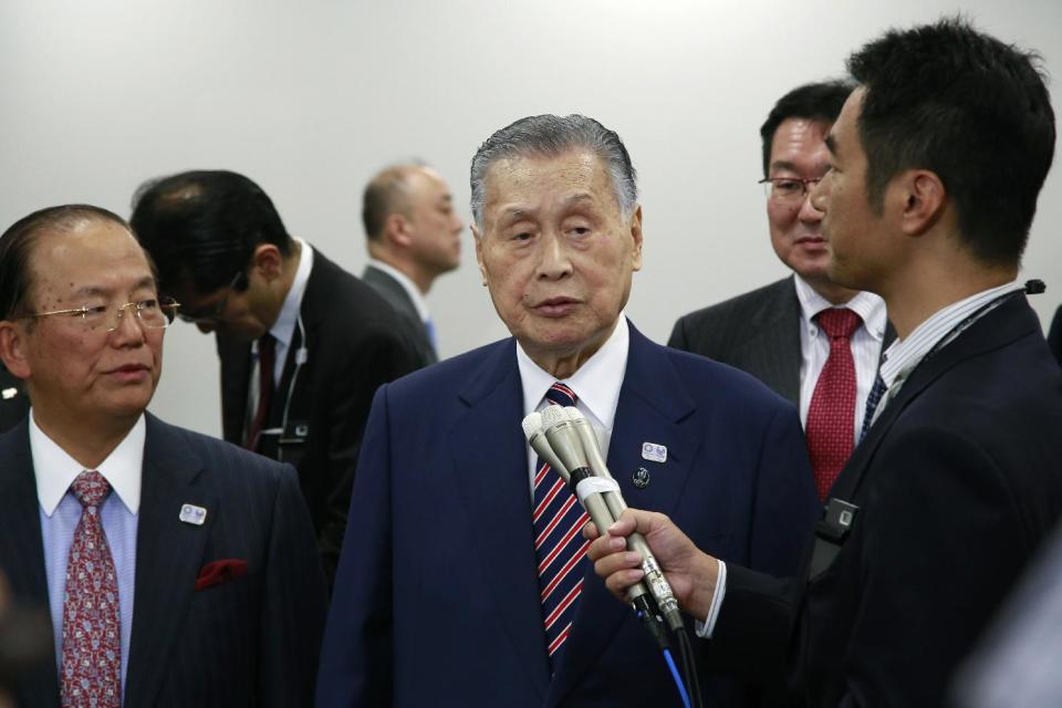 Tokyo Olympics Organizing Committee President Yoshiro Mori, center, answers a reporter's question after the four-party working group meeting in Tokyo, Wednesday, Dec. 21, 2016. Organizers of the Tokyo Olympics estimate the total cost to host the 2020 Games will be between 1.6 and 1.8 trillion yen ($13-$15 billion). The official cost estimate announced Wednesday was slightly below the promised 2 trillion ($17 billion) cap.(AP Photo/Shizuo Kambayashi)