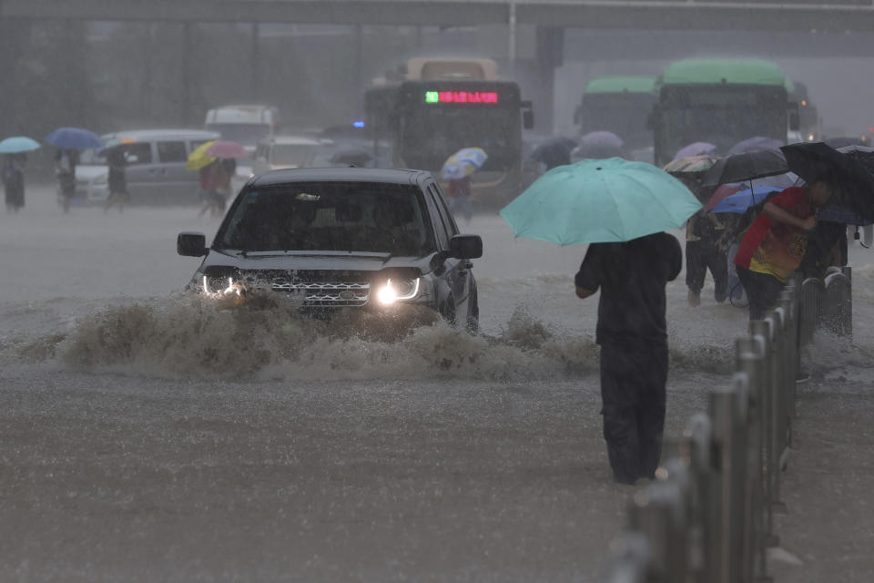 Heavy downpour in Zhengzhou city, central China's Henan province on Tuesday, July 20, 2021. Heavy flooding has hit central China following unusually heavy rains, with the subway system in the city of Zhengzhou inundated with rushing water. (Chinatopix Via AP)