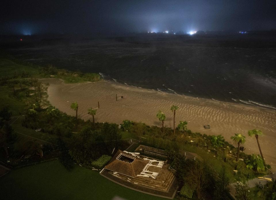 A picture taken on August 27, 2020 shows a destroyed building on a beach as the eye wall of hurricane Laura passes over in Lake Charles, Louisiana. - Hurricane Laura slammed into the southern US state of Louisiana on August 27 and the monster category 4 storm prompted warnings of "unsurvivable" ocean surges and evacuation orders for hundreds of thousands of Gulf Coast residents. The National Hurricane Center (NHC) said "extremely dangerous" Laura would bring winds of 150 miles per hour (240 kilometers per hour) and "destructive waves will cause catastrophic damage" to Louisiana and Texas. (Photo by ANDREW CABALLERO-REYNOLDS / AFP) (Photo by ANDREW CABALLERO-REYNOLDS/AFP via Getty Images)