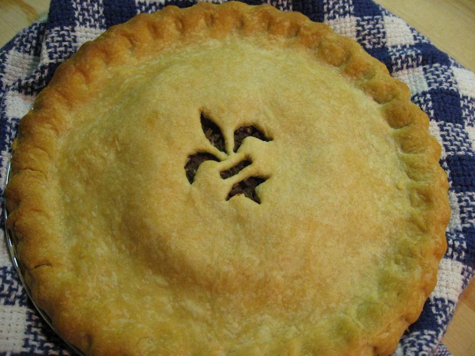 A French meat pie with a fleur-de-lis design in the crust.