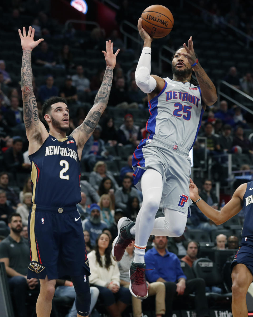 Detroit Pistons guard Derrick Rose (25) attempts a layup as New Orleans Pelicans guard Lonzo Ball (2) defends during the first half of an NBA basketball game, Monday, Jan. 13, 2020, in Detroit. (AP Photo/Carlos Osorio)