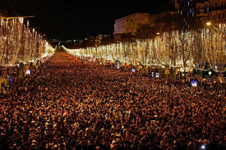 People gathered on the Champs Elysees avenue during New Year's Eve celebrations near the Arc de Triomphe in Paris (REUTERS)